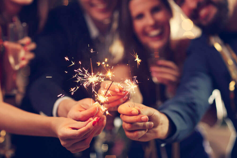 People celebrate the el gordo lottery with sparklers